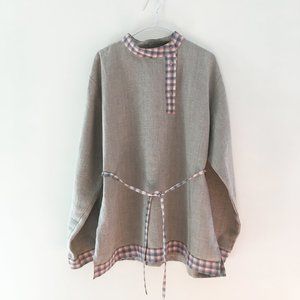 Crude linen shirt with a belt.